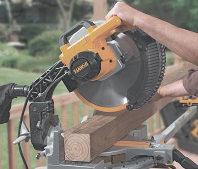 Man using mitre saw to cut the fram wood