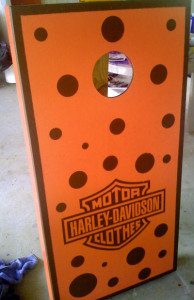 Orange wooden cornhole board